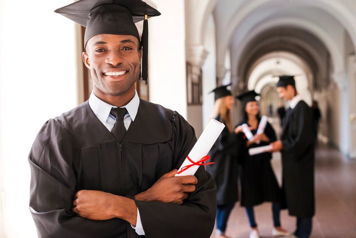 college graduate holding his diploma | Landers McLarty Subaru in Huntsville AL